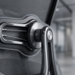 ergonomic office spaces - Professional 16:9 hero banner. Ultra high resolution. A close-up, macro shot of an ergonomic office chair's adjustable lumbar support mechanism, highlighted by a subtle #737373 accent glow emanating from behind the mechanism, casting soft shadows. The chair is positioned in a modern, minimalist UK office environment with a touch of #E2087E in a distant, blurred abstract art piece on the wall. The focus is on the precision engineering and adjustability of the furniture, symbolising expertise and compliance. The overall mood is authoritative and professional, reflecting Cost Cutters UK's experience. Style: Macro detail photography with shallow depth of field. Avoid: Groups of people, generic office scenes, text overlays.