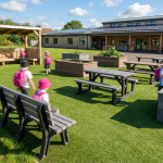 Outdoor Educational Furniture - Professional 16:9 hero banner. Ultra high resolution. A vibrant, sunlit outdoor school playground, seen from a slightly elevated, wide-angle perspective. The scene features children's colourful silhouettes engaged in various outdoor learning activities (e.g., at a picnic table, near sensory planters, on a storytelling bench), but the focus is on the durable, recycled plastic furniture itself. Emphasise the furniture's robust, weatherproof design suitable for the UK climate. The ground is a mix of artificial turf and natural grass. The overall mood is bright and optimistic, suggesting a well-planned, engaging learning environment. Accent lighting in #737373 illuminates key furniture pieces, with subtle hints of #E2087E in the children's accessories or playful elements. Style: Editorial photography with a focus on product clarity and environmental storytelling. Avoid: Overly abstract concepts, generic classroom settings, or people looking directly at the camera.