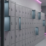 Case Study - Professional 16:9 hero banner. Ultra high resolution. A clear, well-organised school locker bank, rendered in a clean, modern architectural photography style. The lockers are sleek and secure, with individual doors, some slightly ajar to reveal a soft, internal glow in brand accent colour #737373. The background subtly features blurred elements of a calm, focused school hallway, with magenta #E2087E lighting accentuating architectural lines. The overall composition suggests order, security, and a structured approach to managing mobile devices, reflecting the 'Design To Install' expertise of Cost Cutters UK. Style: Architectural photography with subtle, authoritative light play. Avoid: Groups of people, outdated school furniture, abstract patterns that don't relate to physical storage.