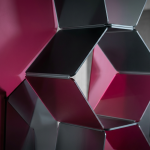Future-Proofing Your Workspace - Professional 16:9 hero banner. Ultra high resolution. A dynamic, abstract geometric pattern representing adaptability and growth, composed of interconnected, translucent panels in shades of #E2087E and #000000. These panels are subtly shifting and reconfiguring, illuminated by a focused, precise #737373 accent glow that highlights their flexible connections. The scene suggests a sophisticated, well-organised commercial interior, with elements that evoke modern office or educational furniture design, without explicitly showing full pieces. The mood is authoritative and forward-thinking. Style: Conceptual architectural photography with dramatic, focused lighting. Avoid: Groups around holographic tables, generic tech aesthetics, text overlays, cold blue tones, stock photo clichés.