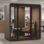 Office Pods and Booths - Professional 16:9 hero banner. Ultra high resolution. A sophisticated, acoustic office pod, seen from a slightly elevated, eye-level perspective inside a modern, subtly blurred open-plan office setting. The pod's interior is softly illuminated with a focused glow of Cost Cutters UK's accent colour #737373, highlighting a comfortable chair and a small table, suggesting a quiet, focused workspace. The exterior of the pod features subtle design elements in Cost Cutters UK's primary tone #E2087E, integrating it seamlessly into the professional environment. The scene emphasizes quiet solitude and productivity within a busy space. Style: Editorial photography, with a shallow depth of field. Avoid: Groups of people, distracting background elements, generic tech aesthetics, text overlays, cold blue tones.