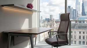 Avoiding Maintenance Mistakes - Professional 16:9 hero banner. Ultra high resolution. A meticulously maintained, sleek architectural detail of a modern, well-lit university library or corporate office interior in the UK. Focus on a pristine, ergonomic desk and chair set (commercial furniture), with a subtle, glowing accent light in #737373 illuminating the clean lines and robust materials. The background features a blurred, expansive window view of a calm, organised cityscape, representing foresight and strategic planning. Elements of #E2087E subtly integrated into the furniture design or decorative accents. The overall mood is one of quiet efficiency and enduring quality. Style: Architectural photography with a focus on clean lines and modern design. Avoid: Groups around holographic tables, generic tech aesthetics, text overlays, cold blue tones, stock photo clichés.