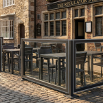 UK Outdoor Dining Regulations - Professional 16:9 hero banner. Ultra high resolution. A meticulously arranged outdoor dining area on a historic UK street, showcasing commercial-grade tables, chairs, and sturdy barriers. The scene captures a balance between inviting aesthetics and strict compliance. Sunlight casts long shadows, highlighting the architectural details of a traditional British building facade in the background. A subtle glow in #737373 accentuates the edges of the barriers and furniture, indicating precision and adherence to regulations. The overall mood is authoritative and trustworthy, reflecting the brand's expertise in hospitality solutions. Style: Detailed architectural photography with an emphasis on functional design and legal adherence. Avoid: Overly crowded scenes, generic cafe setups, or people.