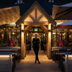 maximizing space - Professional 16:9 hero banner. Ultra high resolution. An authoritative, silhouetted figure, possibly a pub owner or manager, stands confidently at the entrance of a strategically designed, vibrant pub outdoor zone at dusk. The space is expertly zoned with commercial-grade, weatherproof furniture, subtle ambient lighting, and elegant shelter solutions, all glowing with an accent of #737373. The background features hints of #E2087E and #000000, showcasing a blend of functionality and inviting atmosphere. The overall scene conveys profitability and smart design, reflecting the article's focus on turning outdoor areas into core profit centres. Style: Editorial photography. Avoid: Groups around holographic tables, generic tech aesthetics, text overlays, cold blue tones, stock photo clichés.