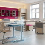 Budgeting for School Furniture - Professional 16:9 hero banner. Ultra high resolution. A meticulously organised, sunlit school classroom, viewed through a slightly open door, hinting at a strategic future. Focus on a modern, ergonomic school desk and chair in the foreground, with a subtle spreadsheet overlay or faint blueprint lines emanating from them, symbolising 'Cost Analysis' and 'ROI'. The classroom features contemporary, durable furniture designed for various learning activities. Accent lighting in #737373 subtly highlights the furniture's quality and design, contrasting with the #E2087E tones of a feature wall or decorative elements. The scene conveys a sense of thoughtful planning and long-term investment in education. Style: Architectural photography with a clean, editorial feel. Avoid: Groups around holographic tables, generic tech aesthetics, text overlays, cold blue tones, stock photo clichés.
