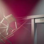 myths vs. facts and a fact - Professional 16:9 hero banner. Ultra high resolution. A visually striking abstract composition contrasting 'myth' and 'fact' through distinct, yet interconnected, geometric forms. On one side, a chaotic, jumbled arrangement of translucent, slightly broken school table parts, cast in a soft, hazy light, symbolising misconceptions and fragility. On the other side, a meticulously arranged, sturdy school table leg section with a clear BS EN 1729 compliance stamp, rendered in sharp focus, with precise, clean lines and robust materials, symbolising verifiable data and durability. A subtle, guiding light in #737373 emanates from the 'fact' side, casting a soft glow on the details, while #E2087E provides a background contrast that highlights the transition. Style: Conceptual still life photography with a focus on contrasting textures and lighting. Avoid: Groups around holographic tables, generic tech aesthetics, text overlays, cold blue tones, stock photo clichés.
